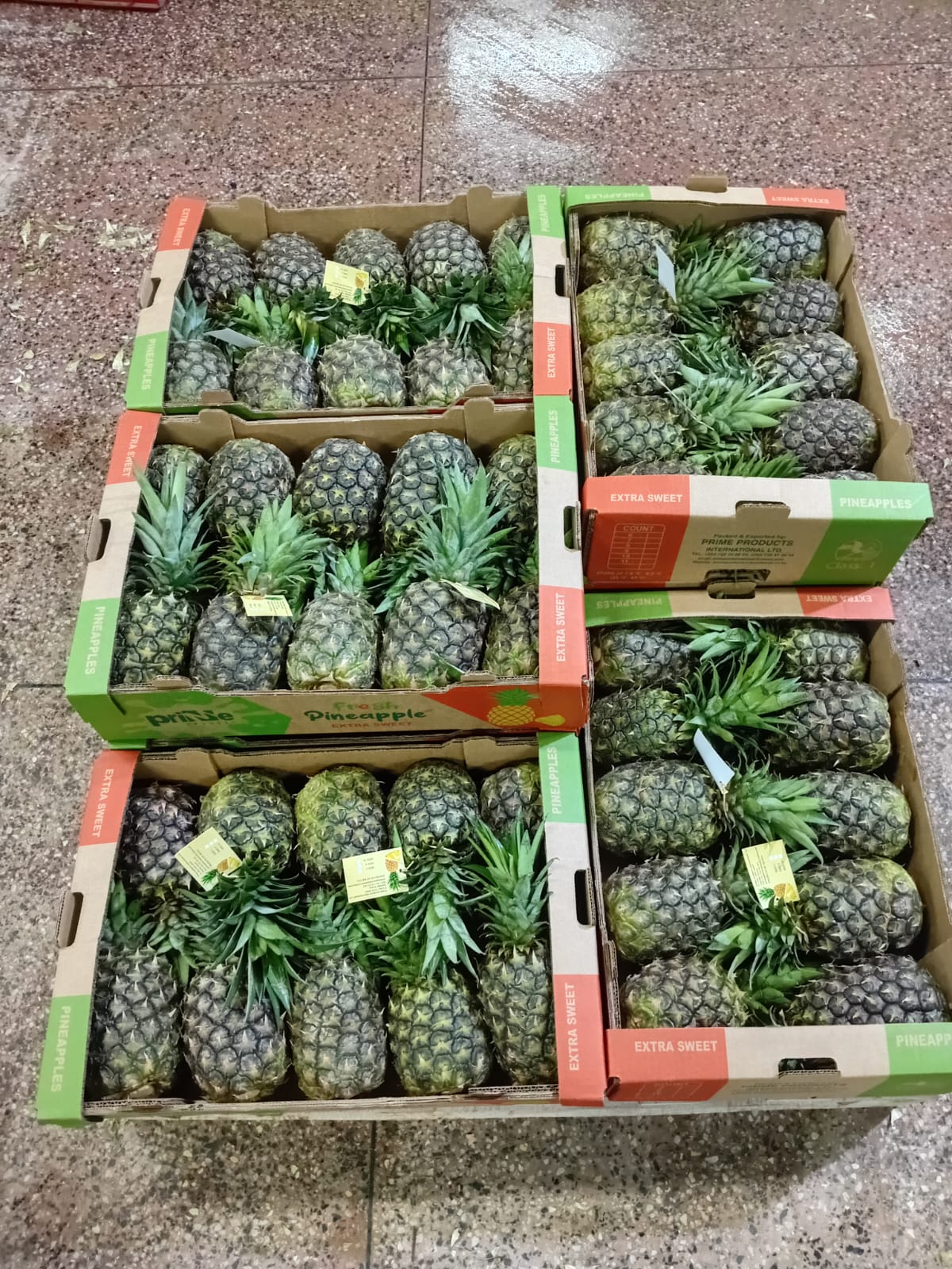 Green mangoes in a crate