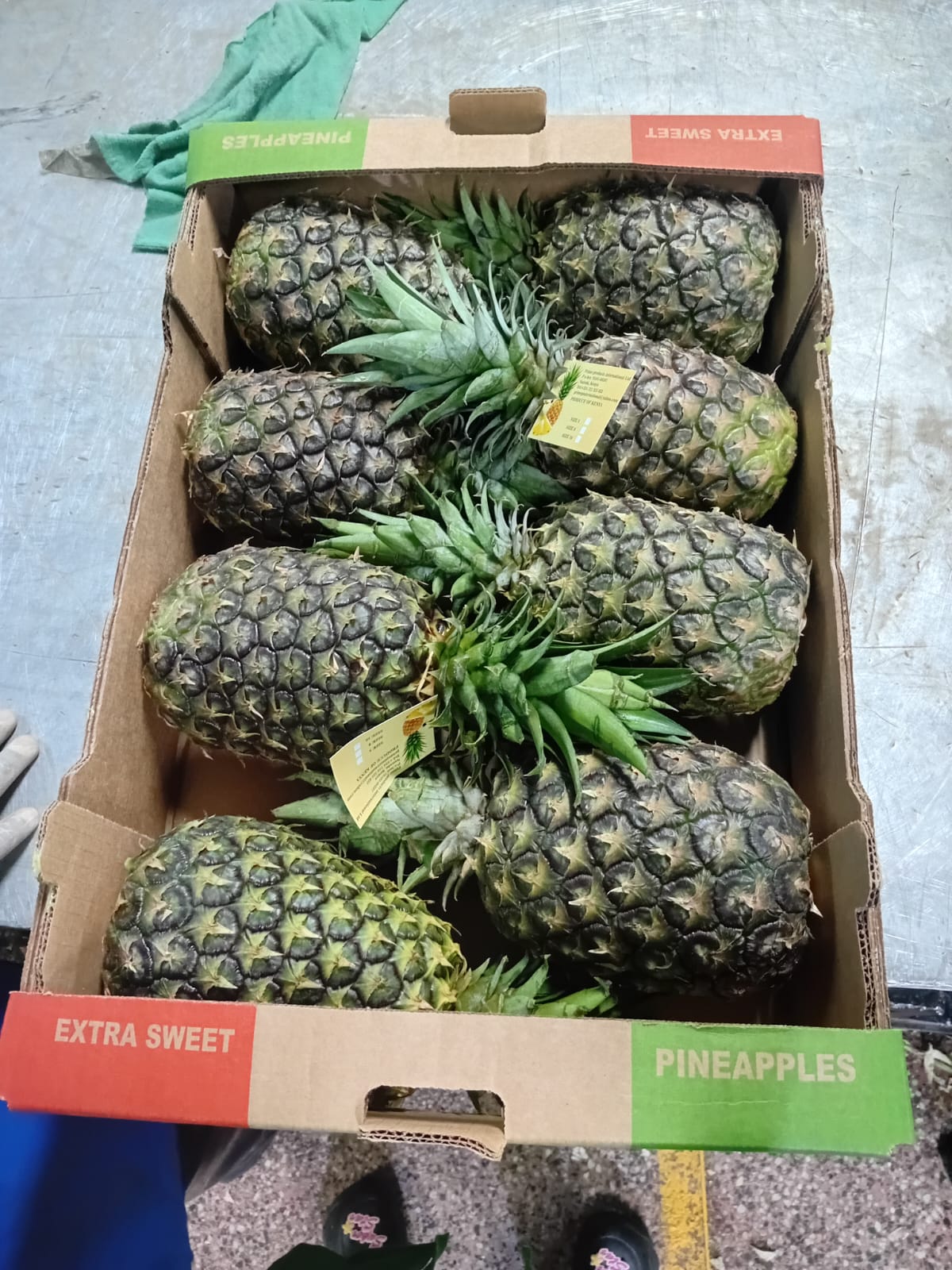 Green mangoes in a crate